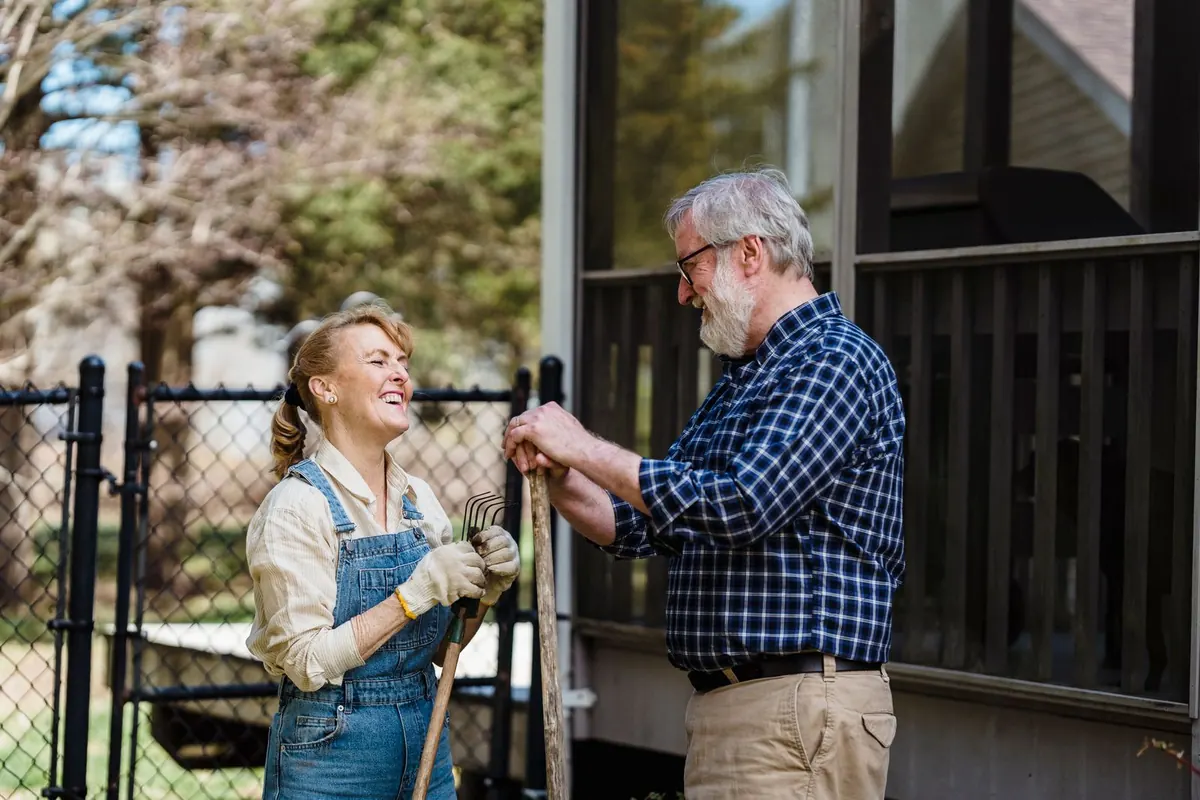 An older couple chatting in their garden